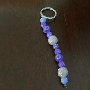A purple beaded keychain